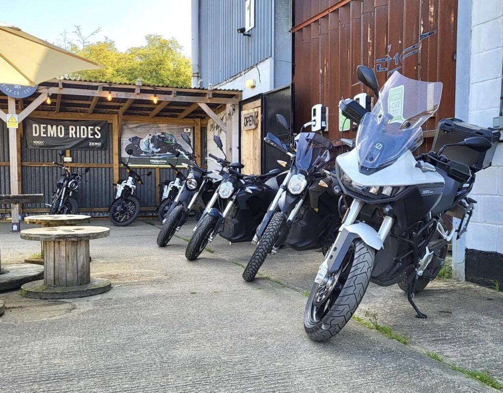 Lineup of electric motorcycles ready for demo rides at the English Electric Motor Co workshop, displaying a variety of eco-friendly bikes for enthusiasts and commuters.