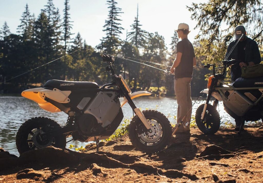 Two LiveWire S4 Honcho electric mini motos beside a lake